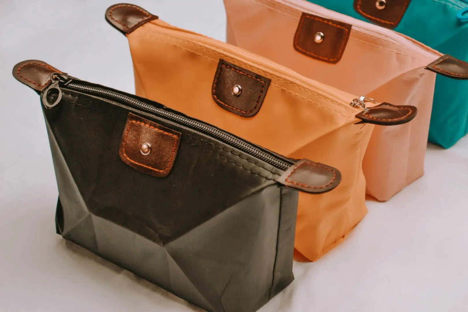 Three different colored bags sitting on top of a table.