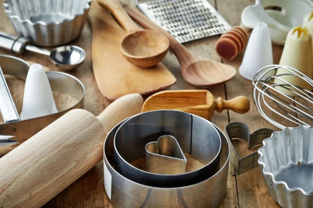 A wooden table with many different utensils on it